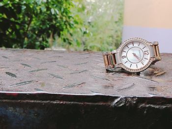 Close-up of clock on stone wall