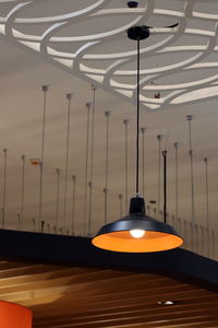 Low angle view of illuminated pendant light hanging from ceiling