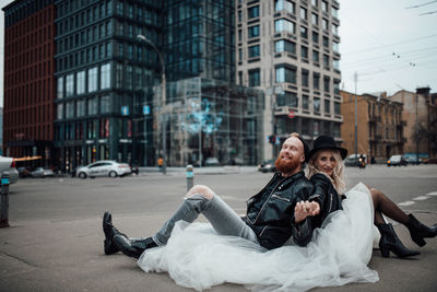 Portrait of friends against buildings in city