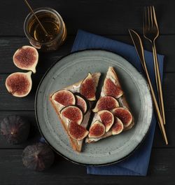 Toasts with cream cheese and fig in the plate flat lay 