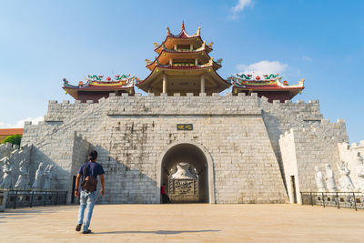 Man walking against building in city