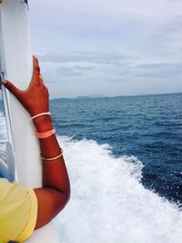 Man in sea against sky