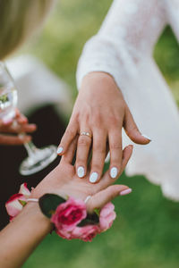 Cropped image of women holding hands during wedding ceremony