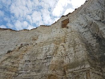 Low angle view of rocky mountain against sky