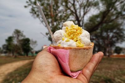 Hand holding ice cream cone