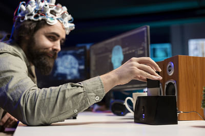 Midsection of man using laptop on table