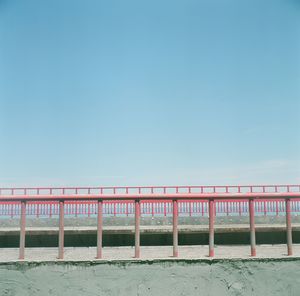 Scenic view of beach against clear blue sky