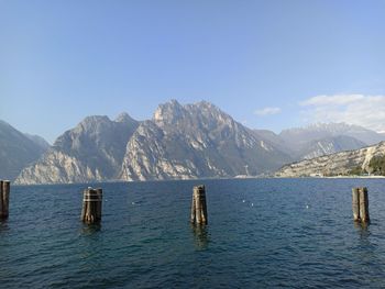 Scenic view of sea and mountains against blue sky