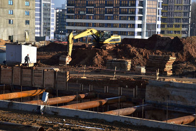 Construction site by buildings in city