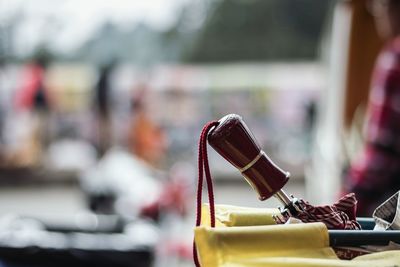 Close-up of umbrella handle and string in bag