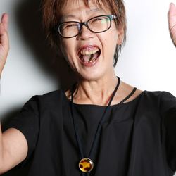 Close-up portrait of happy woman standing against wall