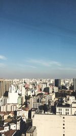 High angle view of buildings against blue sky