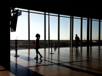 Full length of man standing in corridor against sky