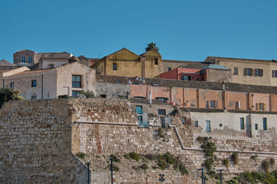 Low angle view of residential buildings against blue sky