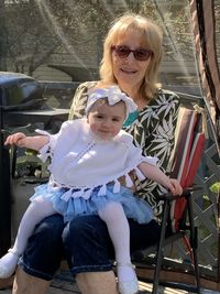 Portrait of a smiling girl sitting outdoors