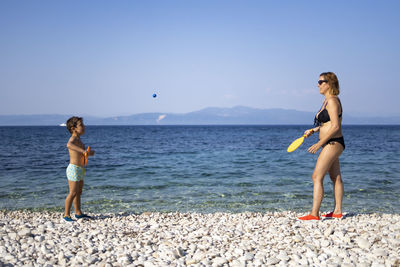 Mother and son playing on the beach