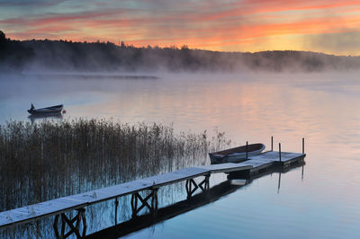 Frozen jetty over water in lake rådasjön at sunrise, mölndal, sweden, europe