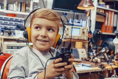 Happy kid using using walkie talkie. 