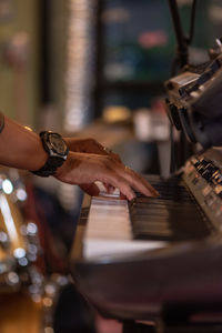 Cropped hands of person playing piano