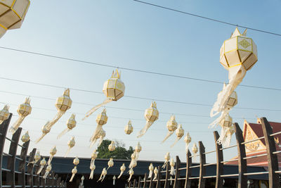 Low angle view of lanterns hanging against clear sky