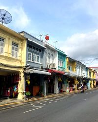 View of city street and buildings against sky