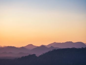 Scenic view of silhouette mountains against sky during sunset