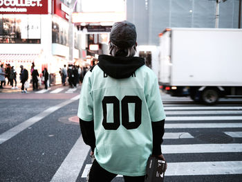 Rear view of man standing on road