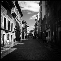 Narrow street amidst buildings in city