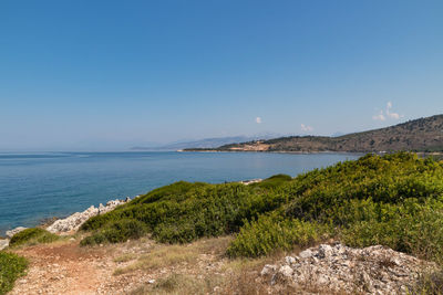 Scenic view of sea against clear blue sky