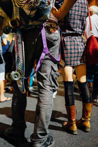 Low section of man walking on street