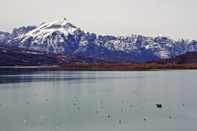 Calm lake against rocky mountains