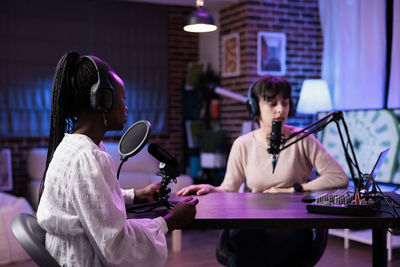 Females vloggers podcasting at studio