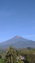 Scenic view of mountains against clear blue sky