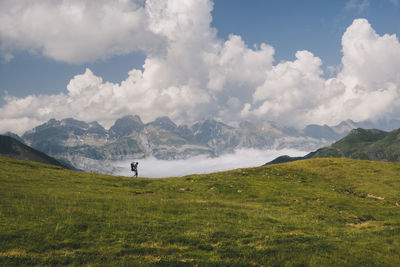 Young man hikes at mt aspe in the pyrenees, while carrying his son.