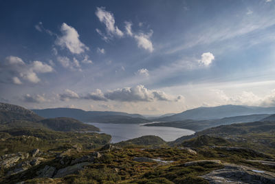 Scenic view of sea and mountains against sky