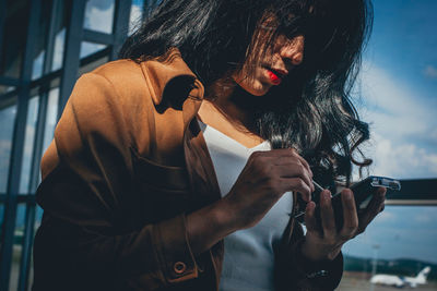 Close-up of young woman using phone