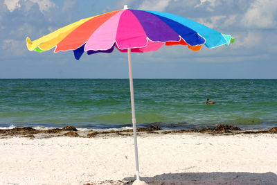 Colorful umbrella at beach on sunny day