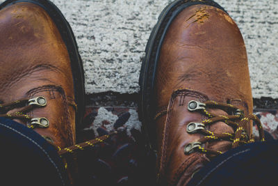 Low section of man wearing leather shoes