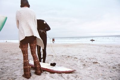 Rear view of man walking on beach