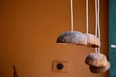 Close-up of old metal hanging against wall