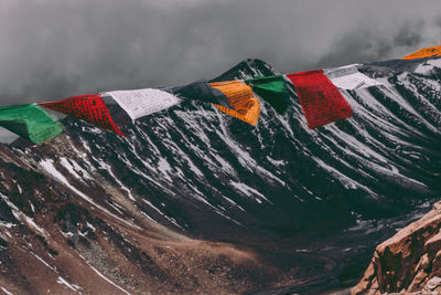 Close-up of flags on mountain against sky