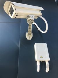 Low angle view of security camera on wall