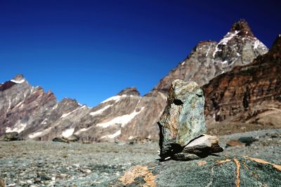 Scenic view of mountains against clear blue sky