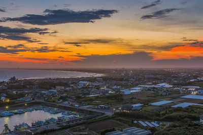 High angle view of city at sunset