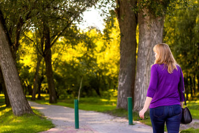 Rear view of young woman standing in park