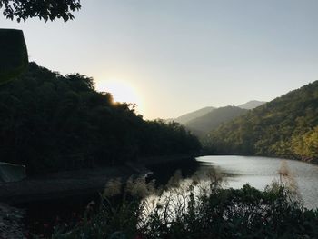 Scenic view of river against sky during sunset