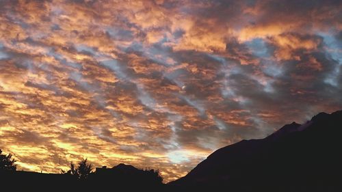 Silhouette of mountain against cloudy sky