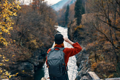 Rear view of man standing in forest