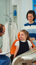 Portrait of young woman sitting at clinic