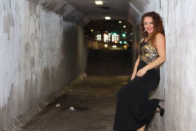 Portrait of young woman standing in tunnel